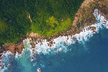 Aerial view of the rugged coastline and lush vegetation on Seger Beach, Kuta, Kecamatan Pujut, Kabupaten Lombok Tengah, Nusa Tenggara Barat, Indonesia