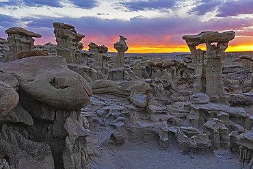 Hoodoos of Valley of Dreams take on fantastical shapes after eons of erosion from wind and rain. This hoodoo is named Alien Throne, with a beautiful sunset sky, Albuquerque, New Mexico, United States of America