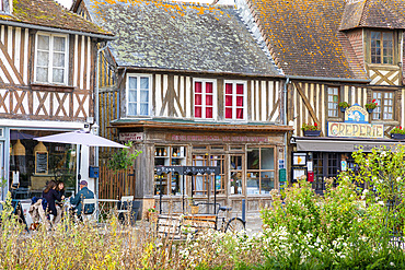 Tourists sitting at cafe in the Normandy village of Beuvron-en-Auge, Beuvron-en-Auge, Normandy, France, Europe