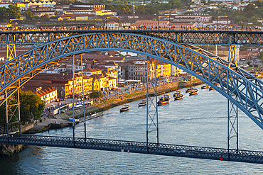 Rabelo Boats on the River Douro with the Dom Luis l Bridge at dusk, UNESCO World Heritage Site, Porto, Norte, Portugal, Europe