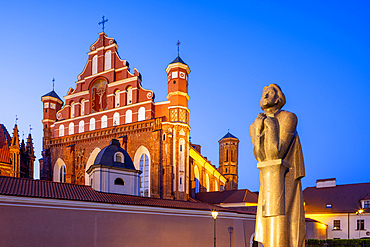 A Statue of the Polish Poet Adam Mickiewicz in front of St. Anne's Church and the Church of St. Francis and St. Bernard at Dusk, Vilnius, Lithuania, Northern Europe