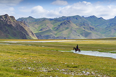 Horseman riding in Kurumduk valley, Naryn province, Kyrgyzstan, Central Asia, Asia