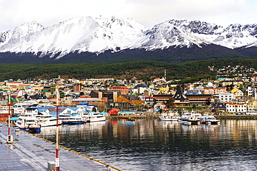 Ushuaia skyline and harbor, the southernmost city of Argentina dominated by snow covered mountains, Tierra del Fuego, Argentina, South America