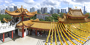 Thean Hou Temple to the Goddess Mazu with yellow chines lanterns and Kuala Lumpur skyline, Malaysia, Asia