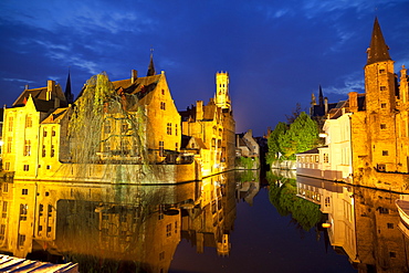 The Belfry and buildings lit up at night along a Canal in the Historic Center of Bruges, UNESCO World Heritage Site, Belgium, Europe