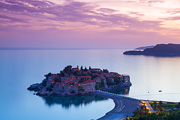 Elevated view over the picturesque island of Sveti Stephan illuminated at dusk, Sveti Stephan, Montenegro, Europe