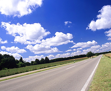 Road and cumulus clouds in summer, Swabian Alb, Baden Wurttemberg, Germany, Europe