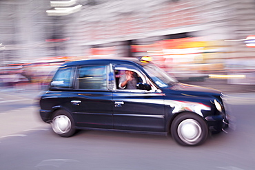 Motion blurred black taxi, Piccadilly Circus, London, England, United Kingdom, Europe