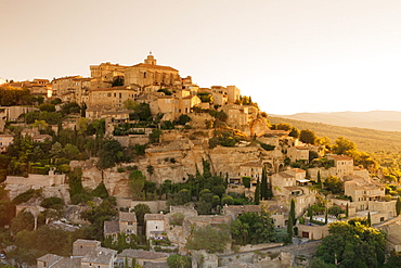 Hilltop village of Gordes with castle and church at sunrise, Provence, Provence-Alpes-Cote d'Azur, France, Europe