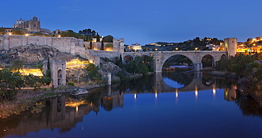 Puente de San Martin Bridge and San Juan des los Reyes Monastery reflected in the Tajo River, Toledo, Castilla-La Mancha, Spain, Europe