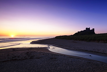 Bamburgh Castle at sunrise, Bamburgh, Northumberland,  England, United Kingdom, Europe