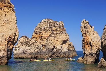 Kayaker exploring Ponta da Piedade Cape, near Lagos, Algarve, Portugal, Europe