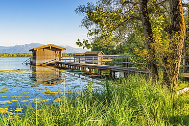 Boat houses on a jetty, Lake Chiemsee, Upper Bavaria, Germany, Europe