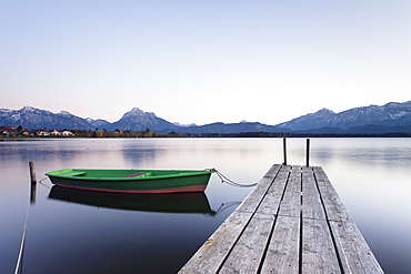 Rowing boat on Hopfensee Lake at sunset, near Fussen, Allgau, Allgau Alps, Bavaria, Germany, Europe