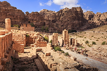 Camel train approaches Temenos Gateway with Qasr al-Bint temple, City of Petra ruins, Petra, UNESCO World Heritage Site, Jordan, Middle East