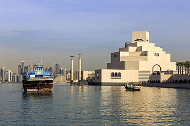 Museum of Islamic Art, dhow and modern city skyline of West Bay, from Al-Corniche, early morning, Doha, Qatar, Middle East