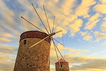 Mandraki Harbour medieval windmills at sunset, Rhodes, Dodecanese, Greek Islands, Greece, Europe