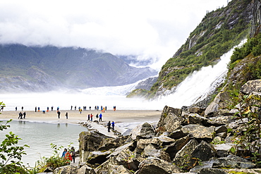 Mendenhall Glacier and Lake, Nugget Falls Cascade, mist, visitors on a beach, Nugget Falls Trail, Juneau, Alaska, United States of America, North America