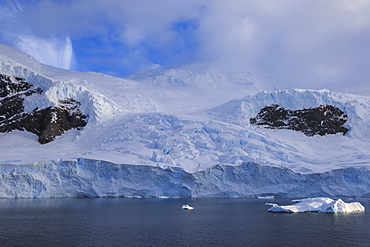 Glacier at sunrise, with atmospheric cloud and mist, Neko Harbour, Andvord Bay, Graham Land, Antarctica, Polar Regions