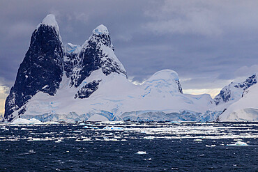 Una Peaks (Una's Tits), basalt ice-capped towers, False Cape Renard, Lemaire Channel entrance, Antarctic Peninsula, Antarctica, Polar Regions