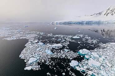 Sun shines through the mist, icy Neumayer Channel between Anvers Island and Wiencke Island, Antarctic Peninsula, Antarctica, Polar Regions