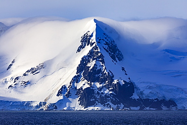 Livingston Island mountains in low lying mist, evening sun, from Bransfield Strait, South Shetland Islands, Antarctica, Polar Regions