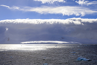 Arcus cloud over the mountains of the Gerlache Strait, blue sky, Antarctic Peninsula, Antarctica, Polar Regions