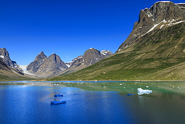 Pyramidal peaks, blue icebergs, glaciers, rugged South Skjoldungen Fjord, glorious weather, remote South East Greenland, Denmark, Polar Regions