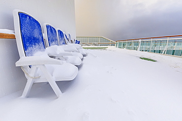 Cruise ship on an Arctic Winter voyage, fresh powder snow on decks, off Troms County, North Norway, Scandinavia, Europe