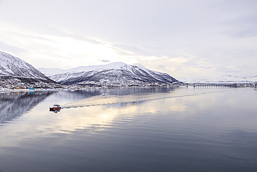 Tromso city, from its fjord, city covered in winter snow, boat, Arctic Cathedral, bridge, mountains, Tromso, Troms og Finnmark, North Norway, Scandinavia, Europe