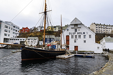 Beautiful Alesund, waterfront, historic boat, wooden warehouse in winter, Alesund, More og Romsdal, Norway, Scandinavia, Europe