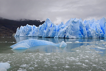 Lake-level view of blue ice at the glacier face and iceberg, Grey Glacier, Torres del Paine National Park, Patagonia, Chile, South America