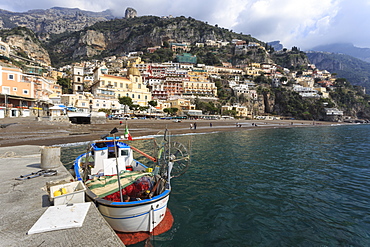 Fishing boat at quayside and Positano town, Costiera Amalfitana (Amalfi Coast), UNESCO World Heritage Site, Campania, Italy, Europe