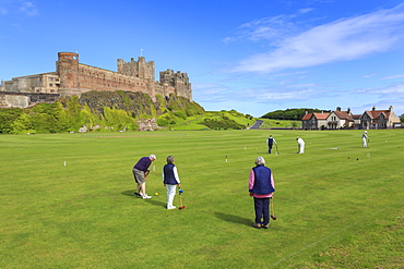 Playing croquet beneath Bamburgh Castle on a bright summer afternoon, Bamburgh, Northumberland, England, United Kingdom, Europe