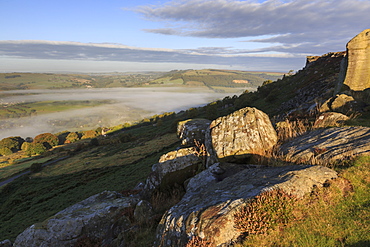 Mist clears from valley, fields and woods, from Curbar Edge at sunrise, autumn dawn, Peak District, Derbyshire, England, United Kingdom, Europe