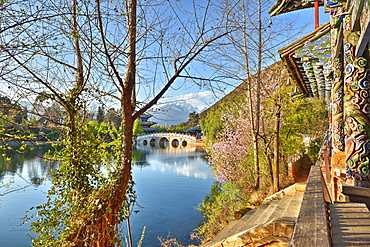 Colourful Yunnan wood carvings with Suocui Bridge and Moon Embracing Pavilion, Lijiang, Yunnan, China, Asia 