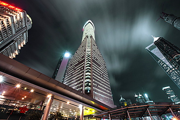 Low angle view of skyscrapers in Shanghai Pudong at night, with moving clouds, Shanghai, China, Asia