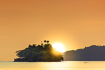 The sun setting behind islets in the Banda archipelago, Banda, Maluku, Spice Islands, Indonesia, Southeast Asia, Asia