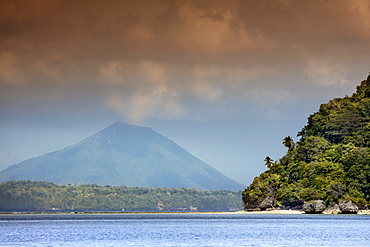 View of the cone of Gunung Api Wetar volcano from Nailaka island, Banda Islands, Maluku, Spice Islands, Indonesia, Southeast Asia, Asia