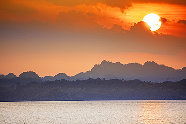 Sunset over limestone karst islands, Raja Ampat, West Papua, Spice Islands, Indonesia, Southeast Asia, Asia