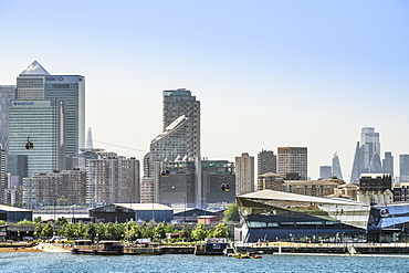 An Emirates cablecar and the skyline of London's financial centres with Canary Wharf and Docklands behind the City of London, London, England, United Kingdom, Europe