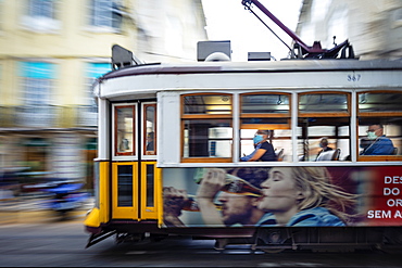 A traditional historic Remodelado electric tram moving through the centre of the city, Lisbon, Portugal, Europe