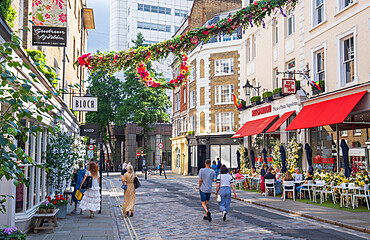 Restaurants and pedestrians on Monmouth Street, a shopping street near Seven Dials, Covent Garden, West End, London, England, United Kingdom, Europe