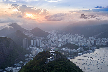 Sunset over the city skyline and Rio's mountains and beaches from the summit of Sugar Loaf mountain, Rio de Janeiro, Brazil, South America