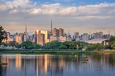 The downtown urban skyline reflected in Lago das Garcas lake at twilight, Ibirapuera Park, Sao Paulo, Brazil, South America