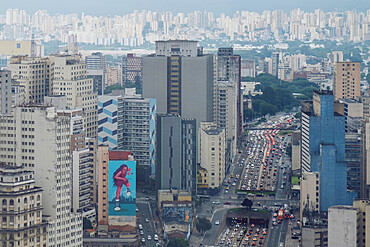 Elevated view of downtown skyscrapers, heavy traffic on Avenue Prestes Maia, rainy season sky, Sao Paulo, Brazil, South America