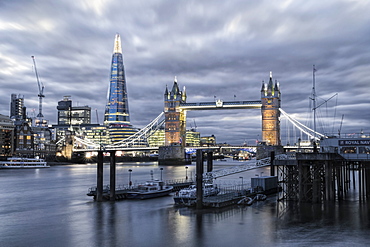 The River Thames, Tower Bridge, City Hall, Bermondsey warehouses and the Shard at night shot from Wapping, London, England, United Kingdom, Europe