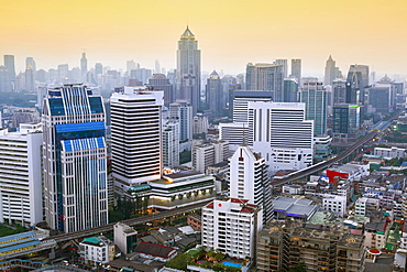 City skyline looking along the BTS Skytrain, Sukhumvit Road and Phloen Chit, with the Baiyoke Tower II to the right of frame, Bangkok, Thailand, Southeast Asia, Asia