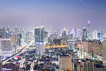 City skyline looking along the BTS Skytrain, Sukhumvit Road and Phloen Chit, with the Baiyoke Tower II to the right of frame, Bangkok, Thailand, Southeast Asia, Asia