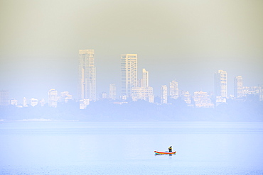 A fisherman in front of the skyscrapers of the Malabar Hills in Mumbai (Bombay), Maharashtra, India, Asia